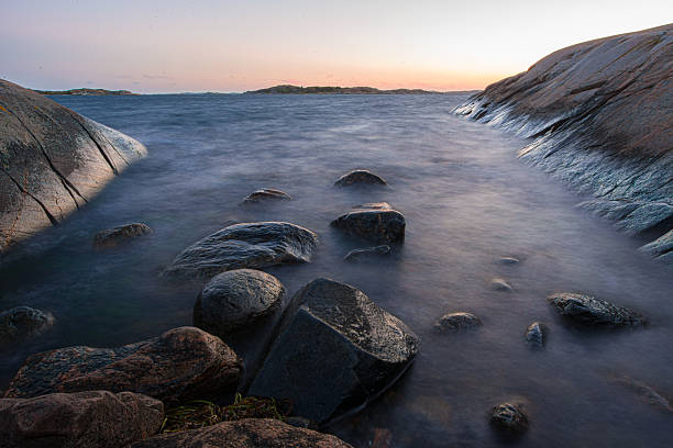istock Tranquil rocky shoreline enveloped in soft mist.. 2227400994