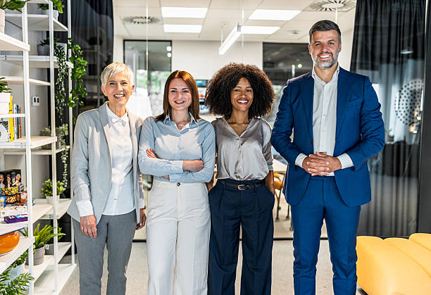 istock Business team smiling at camera in modern office 2227401234
