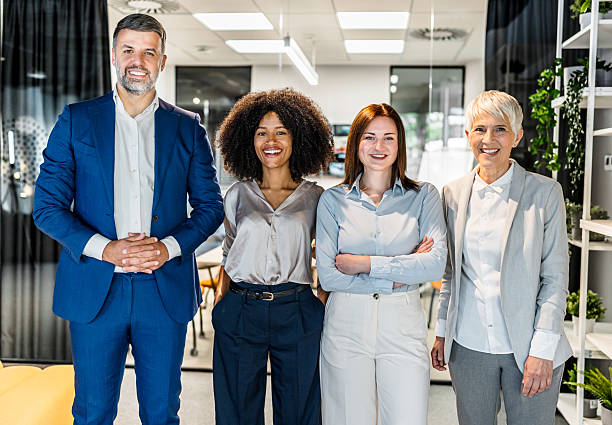 istock Smiling business team posing together in modern office 2227402090