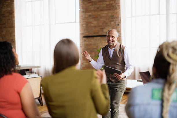 istock Mature businessman leading a meeting with his team using a tablet 2227404315