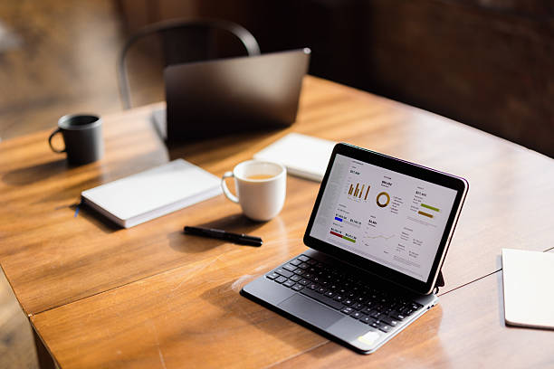 istock Businessman analyzing financial charts and graphs on a tablet in the office 2227404318