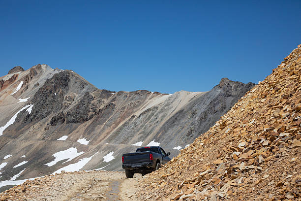 istock Pick-up truck drives through high mountain pass 2227404436
