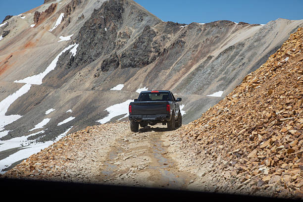 View through window of 2nd vehicle, under blue skies, Utah