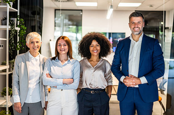 istock Smiling business team posing together in modern office 2227404525