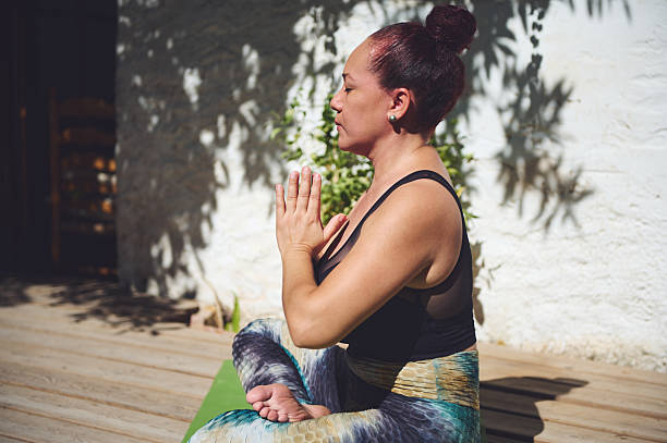 istock Woman Practicing Yoga in Seated Pose Outdoors in Natural Light 2227404680