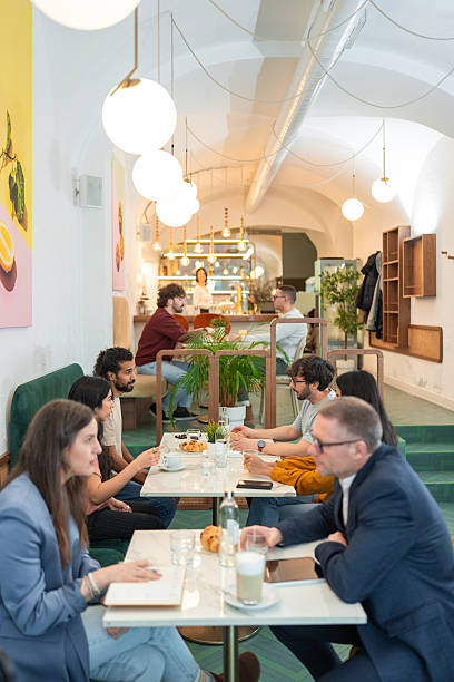 istock Cozy Bistro Interior with Diverse People Enjoying Meals Under Warm Pendant Lighting 2227404912