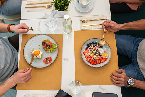 istock Modern Brunch Setting with Diverse Dishes in Cozy Bistro Enjoyed by Two People 2227404928
