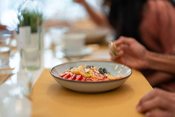 Modern Bistro Brunch Setting with Fresh Fruit and Granola in Warm Sunlit Ambiance