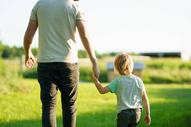 Father and Son Walking Together Outdoors on a Sunny Day