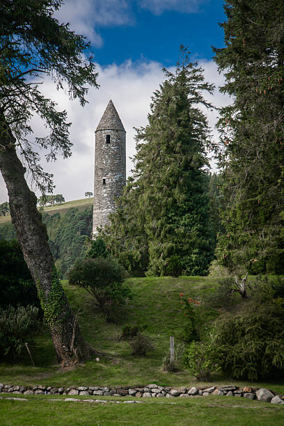 Aerial view of Glendalough ruins in Wicklow Ireland, Aerial view of Glendalough monastery, aerial view of Glendalough upper and lower lakes in Ireland, aerial view of ireland nature, popular tourist destination in IrelandGlendalough is a glacial valley in County Wicklow, Ireland, renowned for an Early Medieval monastic settlement founded in the 6th century by St Kevin. From 1825 to 1957, the head of the Glendalough Valley was the site of a galena lead mine. Glendalough is also a recreational area for picnics, for walking along networks of maintained trails of varying difficulty, and also for rock climbing.