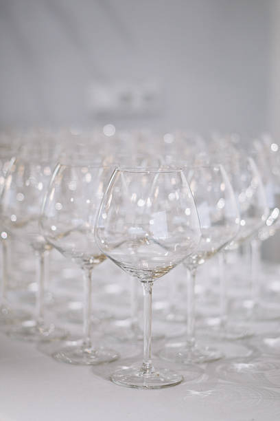 A row of elegant empty wine glasses sparkles in soft focus, creating a refined and festive atmosphere. High quality photo