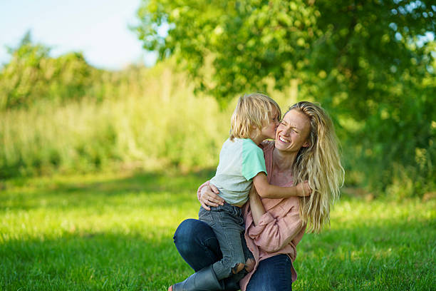 istock Mother and Son Sharing a Laugh Outdoors in a Sunny Park 2227407924