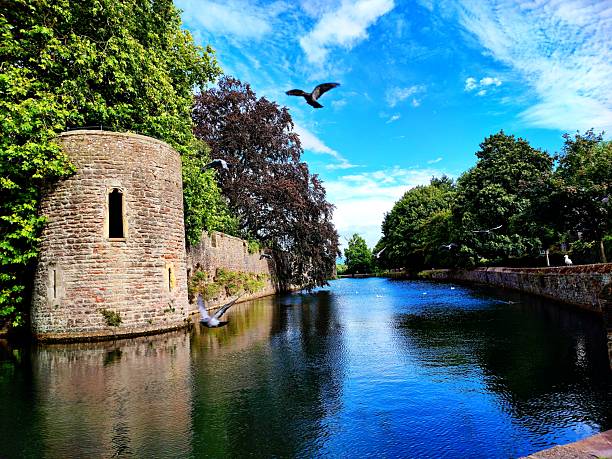 A river in Wells Somerset, with a tower on the left, a walkway on the right.