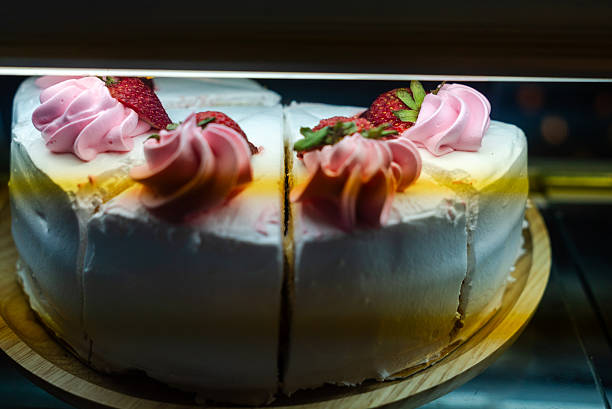 A beautifully decorated cake featuring fresh strawberries and creamy frosting, perfect for celebrations or as a delightful dessert for any occasion.