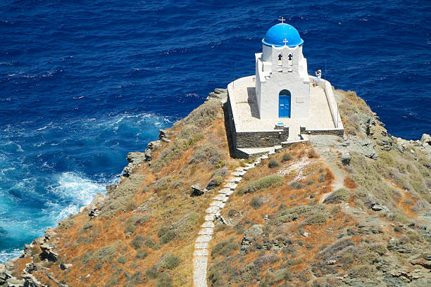 Sifnos Island, Greece, Cyclades Island Chain. July 07, 2025\nThe small Greek Orthodox Monastery of  Efta Martyres in front of the deep blue color of the Aegean Sea.