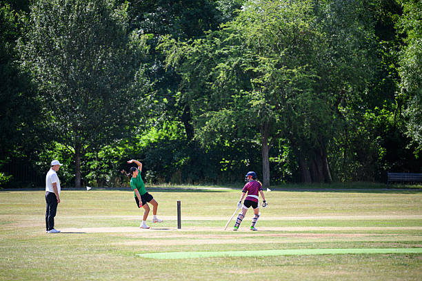 istock Batter ready to run as bowler lines up to bowl referee watching closely 2227410899