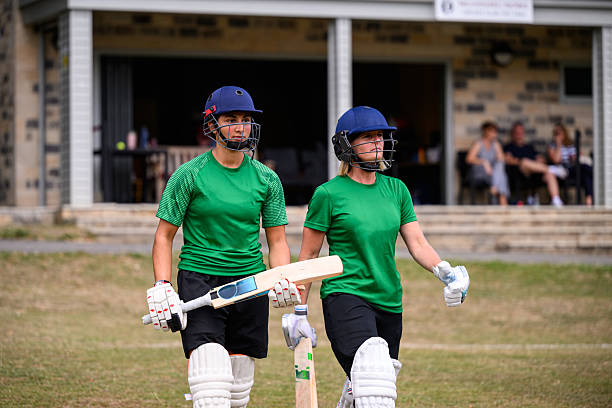 istock Front view mixed age female batting team walking on to cricket field 2227410992