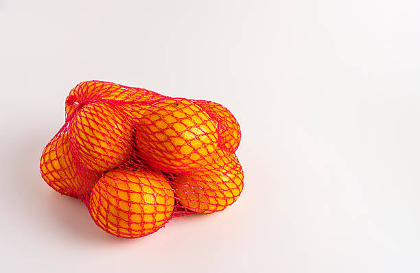istock Fresh citrus fruits in net packaging 2227411384