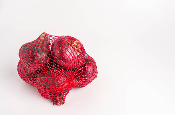 istock Bundle of raw red onions in mesh bag 2227411448