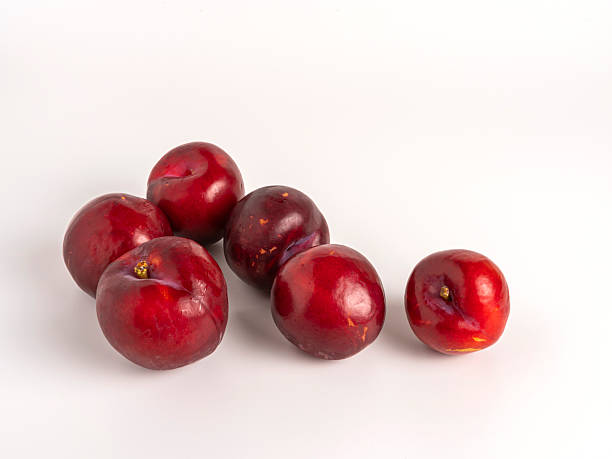 istock Ripe red plums isolated on white background 2227411693