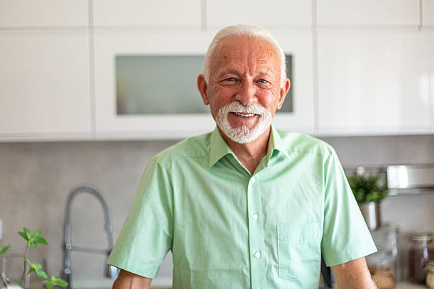istock Portrait of a smiling senior man leaning on kitchen counter 2227412949