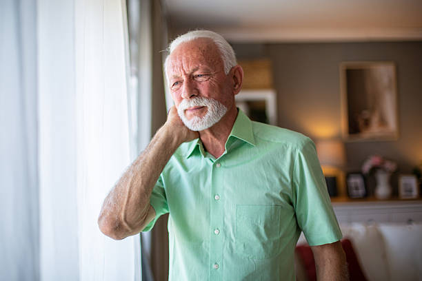istock Senior man suffering from neck pain at home 2227413565