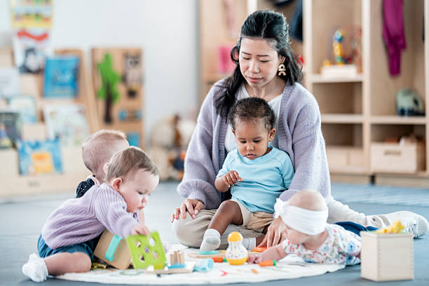 istock Childcare Setting with Educator and Toddlers Engaged in Play 2227414289