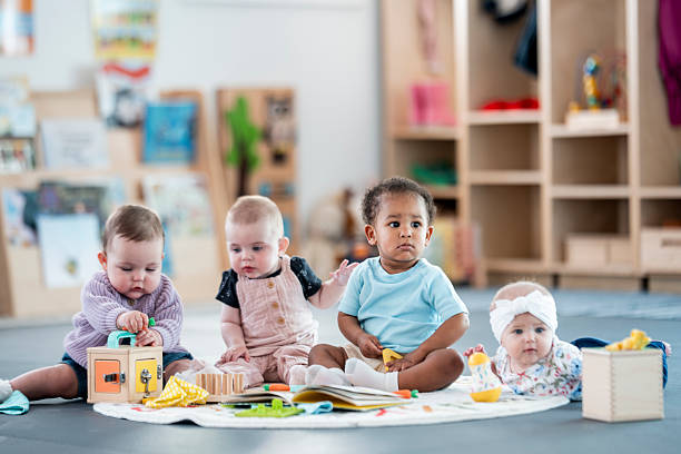 istock Group of Adorable Babies Playing Together in a Colorful Classroom Setting 2227414490