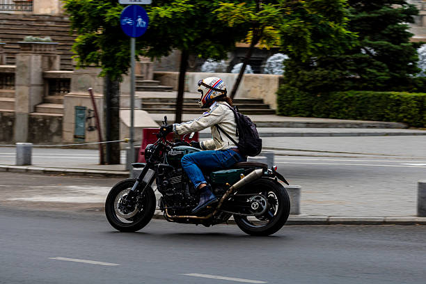 Vintage motorcycle on the street, standing in front of a red colored wall