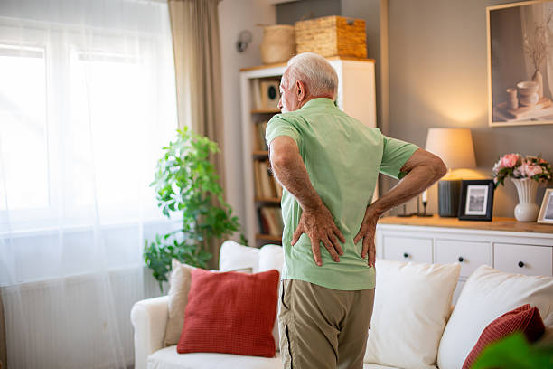 istock Senior man suffering from back pain at home 2227415759