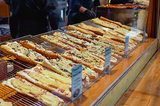 istock Pizza display case. Baked baguette pizzas topped with melted cheese and various toppings displayed in bakery counter. Concept of fast food, cheesy delight, street snacks 2227416338