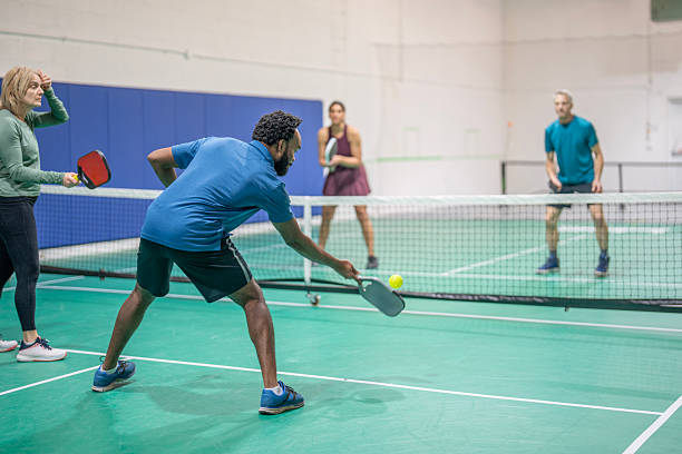 istock Group Playing Pickleball in Indoor Court Setting 2227416997