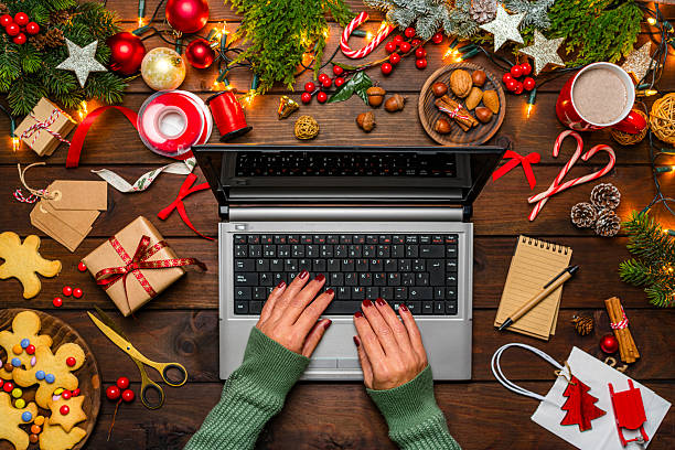 istock Woman using laptop on Christmas decorated table. Online shopping or App concept. E-commerce or consumerism. Shopping for Christmas or December holidays 2227418409