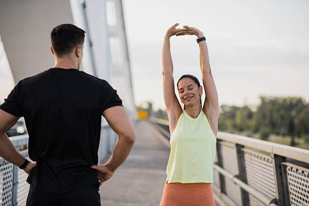istock Young woman stretching body as trainer coaches her 2227418774