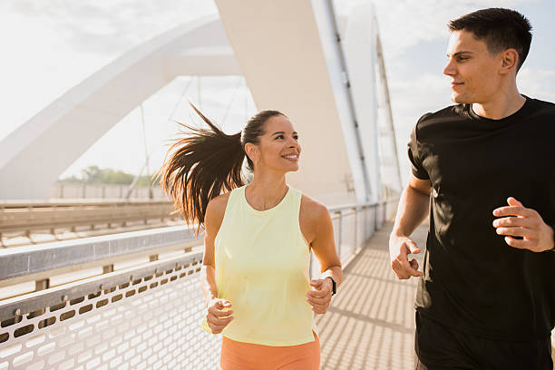 istock Young couple running side by side, sharing a loving smile 2227421416