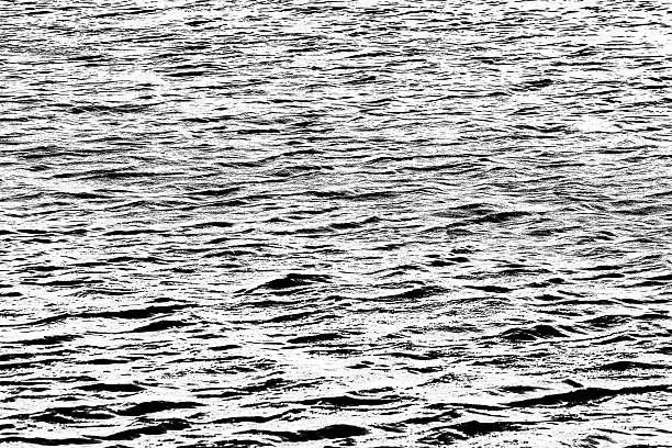 black and white textured image of a gently rippled sea surface