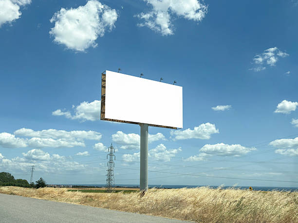 istock Billboard with green field and sky background (Frame with Clipping Path) 2227422421