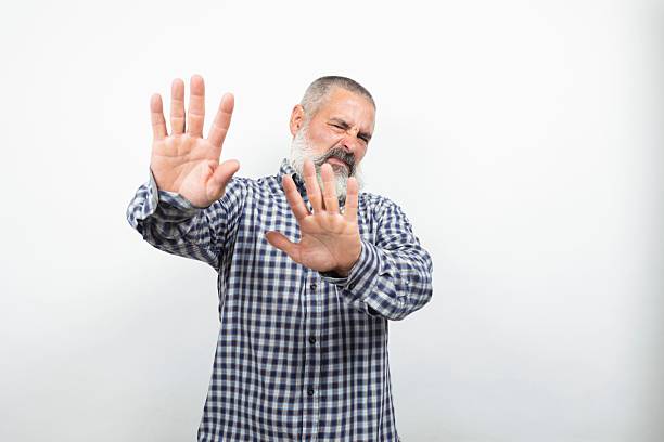 istock Senior man showing stop sign with both hands and rejecting something 2227425368