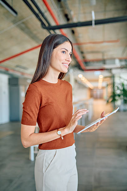 istock Young businesswoman using digital tablet in modern office space 2227426021