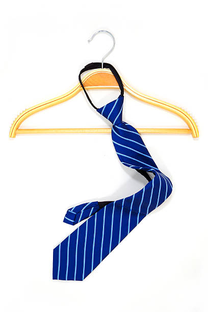 istock Striped pattern blue tie hanging on wooden hanger with white background close-up view 2227426190
