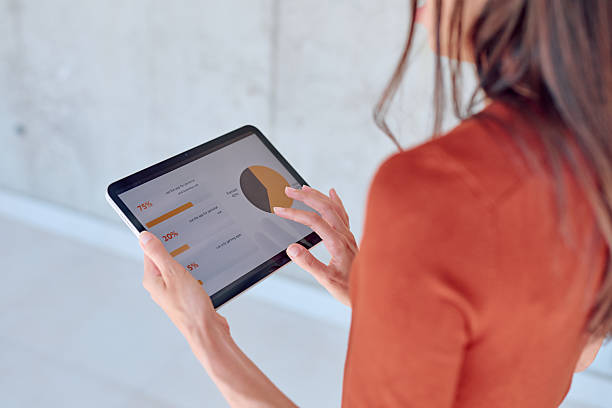 istock Businesswoman analyzing financial charts and graphs on digital tablet 2227426496