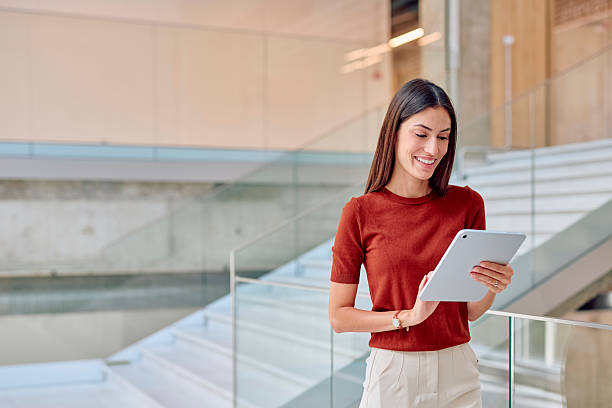istock Smiling businesswoman using digital tablet in modern office building 2227426645