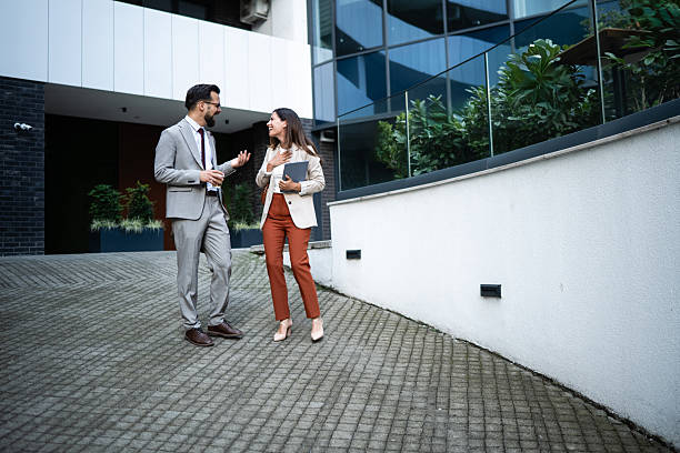 istock Business people talking and walking outside office building 2227427166