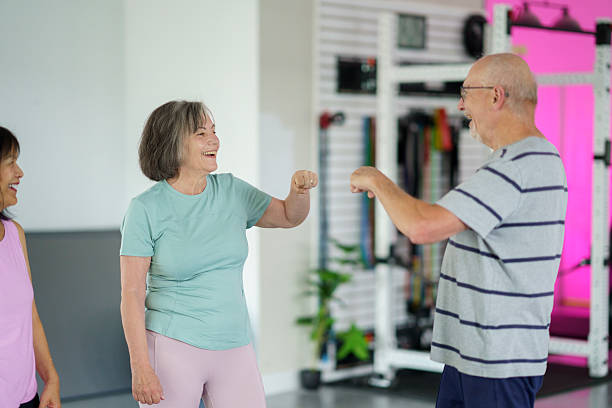 istock Seniors Interacting and Socializing During a Fitness Class in a Gym Setting 2227430907