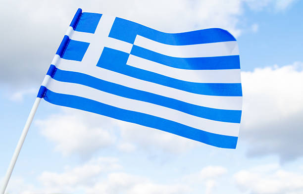 istock Waving flag of Greece on blue sky background. 2227430911
