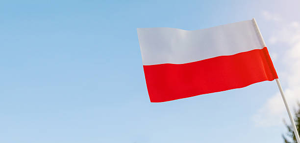 Close up of Polish flag against blue sky