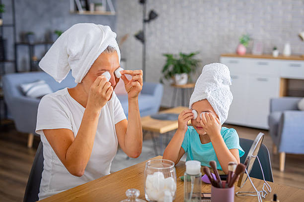 istock Mother and daughter sharing a joyful moment with makeup fun 2227431208