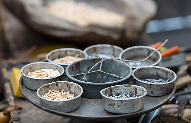 Rustic metal containers holding assorted small wooden objects.