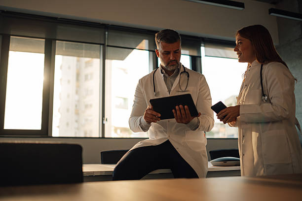 istock Doctors using digital tablet and smartphone in hospital room 2227433804