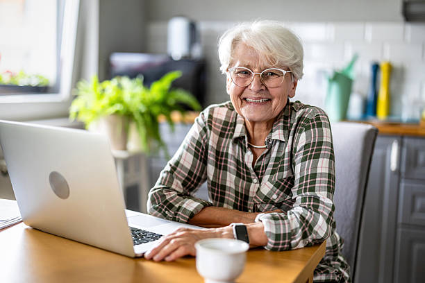 istock Senior woman using laptop at home 2227434166
